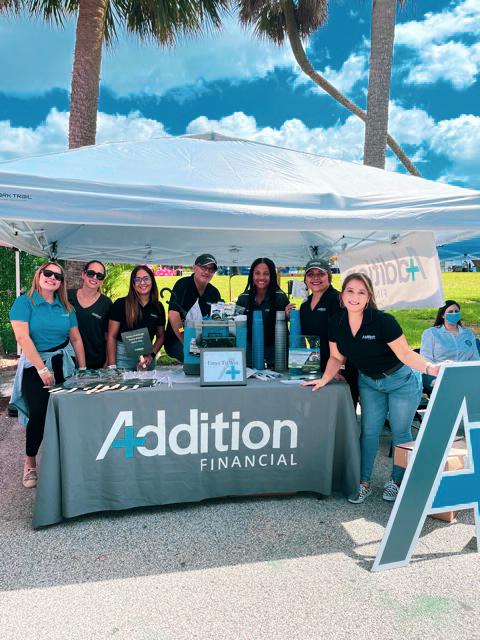 Addition Financial team members at a community event