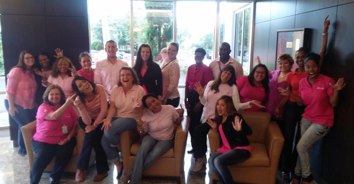addition financial employees wearing pink shirts