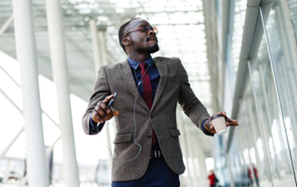 Man in suit listening to headphones