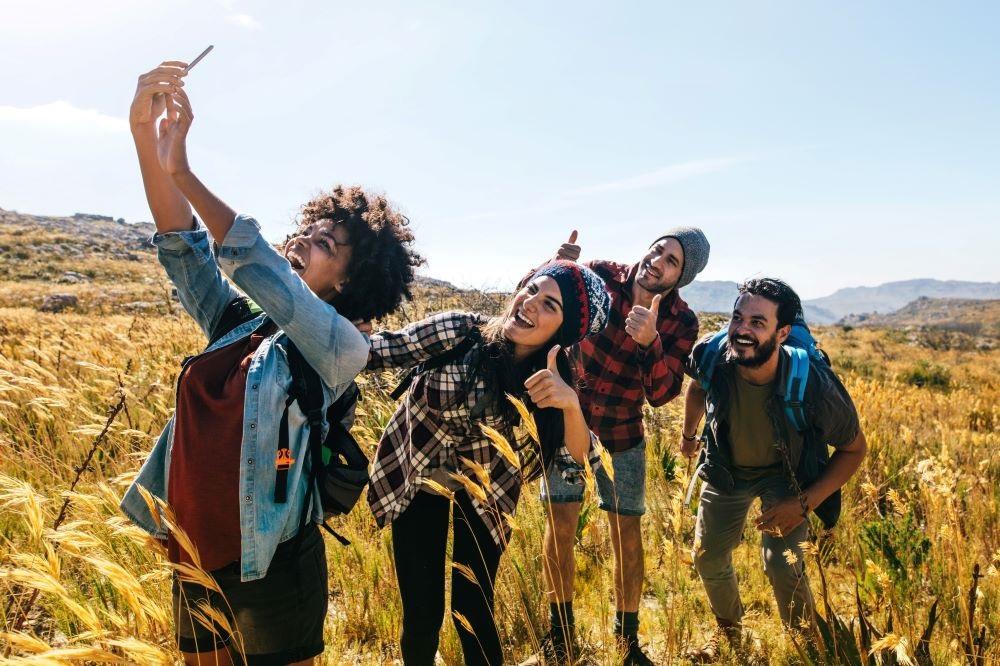 A group of young people taking a photo in a field