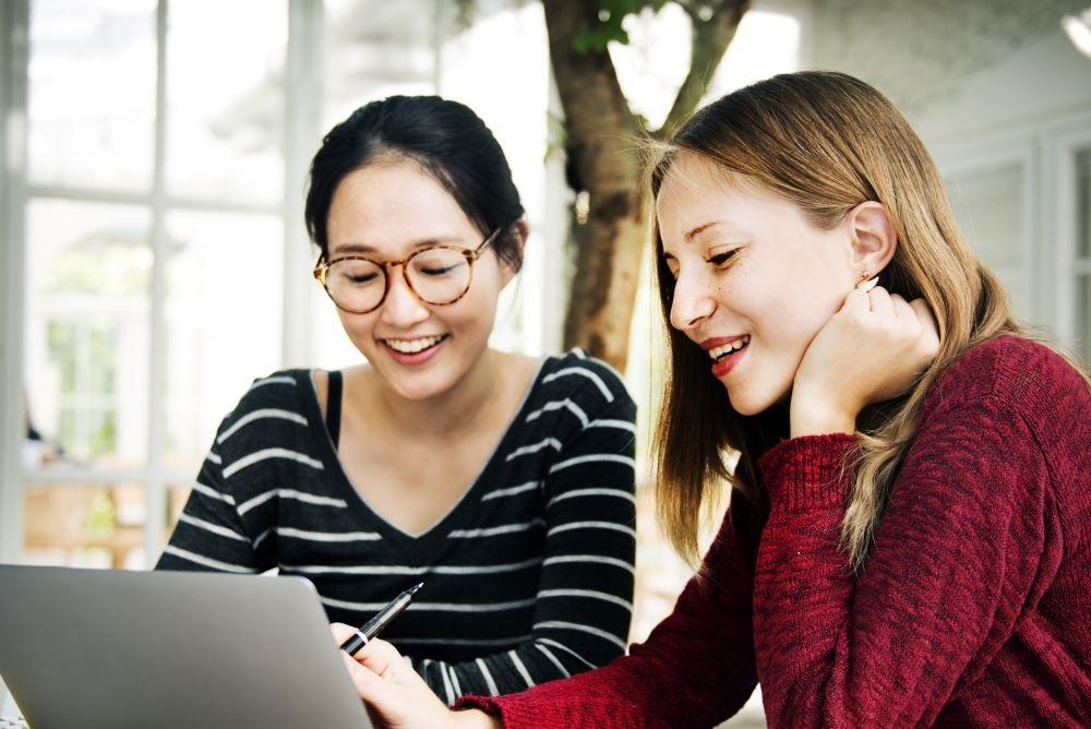 Two young people looking at a computer screen