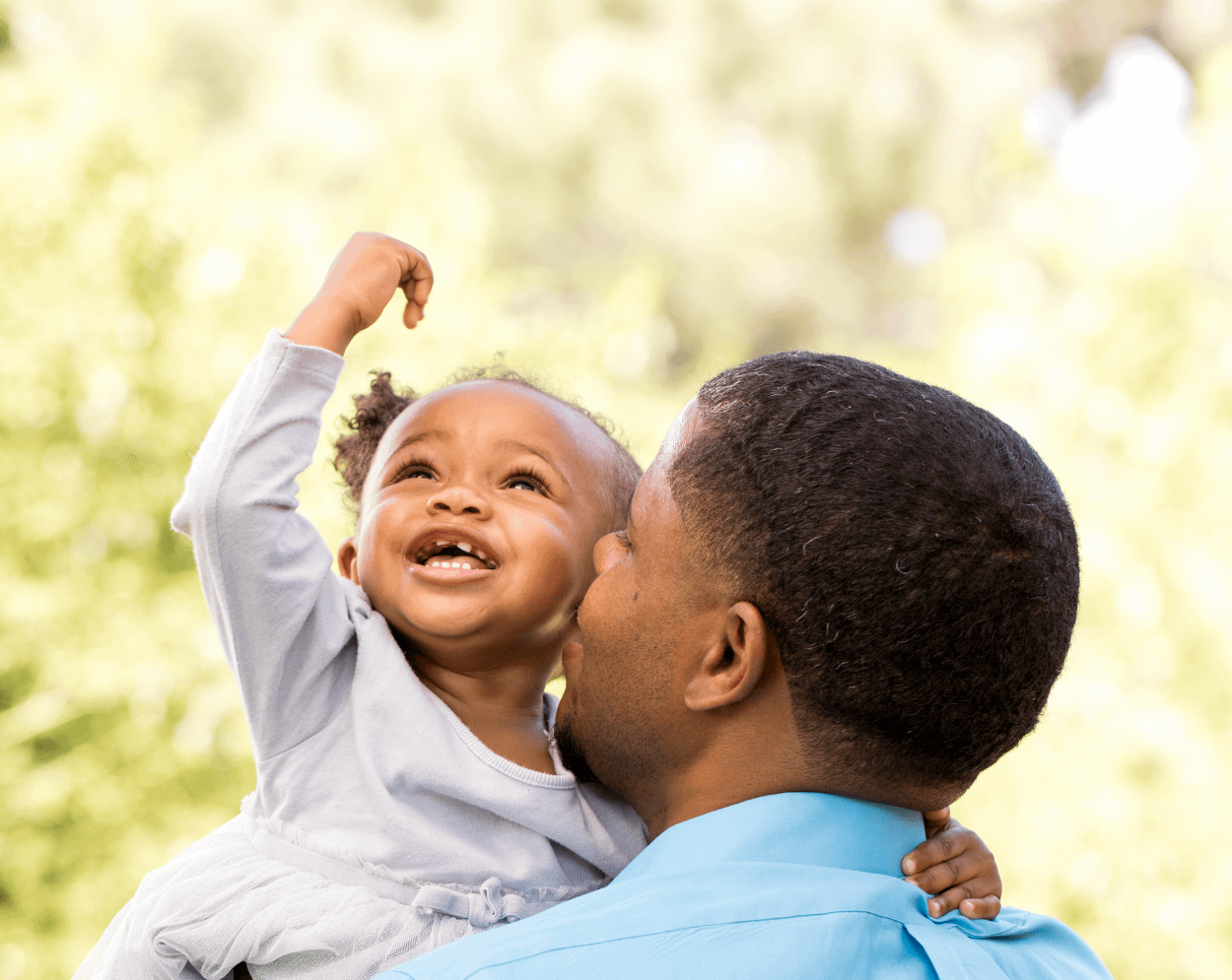 Man kissing his baby's cheek.