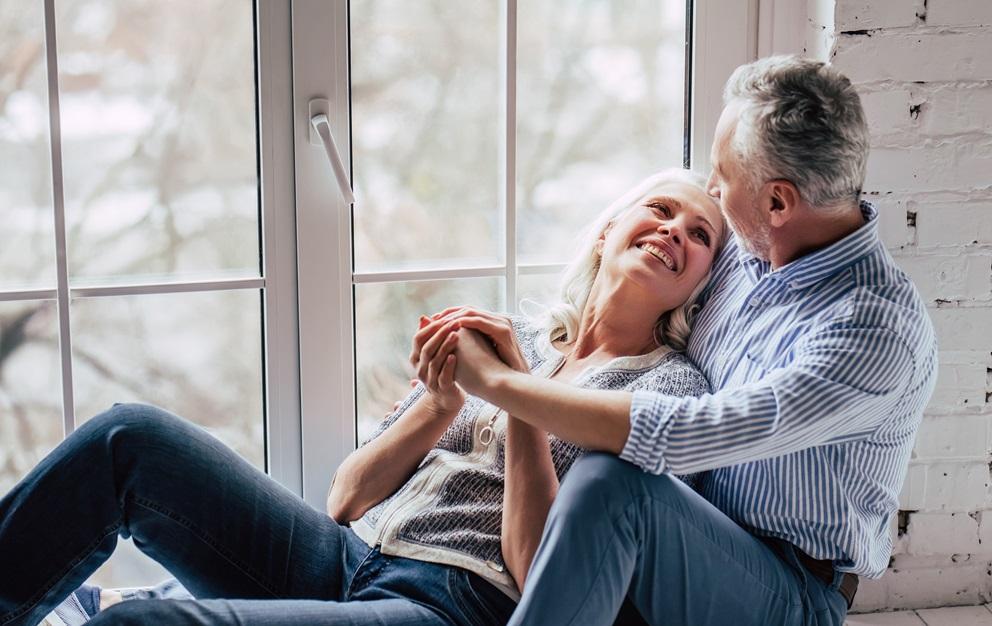 Couple sitting together on a windowsill